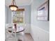 Charming breakfast nook with wood table, white chairs, and bright natural light at 7887 Limestone Ln # 12-102, Sarasota, FL 34233