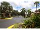 Gated entrance with lush landscaping, offering security and a welcoming arrival to this community at 7887 Limestone Ln # 12-102, Sarasota, FL 34233