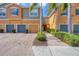 Charming townhome exterior with a private driveway and well-maintained landscaping at 7887 Limestone Ln # 12-102, Sarasota, FL 34233
