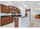 Well-lit kitchen with granite countertops, stainless steel appliances, and dark wood cabinets at 7887 Limestone Ln # 12-102, Sarasota, FL 34233