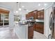 Bright kitchen featuring an eat-in bar, wood cabinets, and stainless steel appliances at 7887 Limestone Ln # 12-102, Sarasota, FL 34233