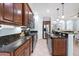 Galley kitchen boasts dark granite countertops, stainless appliances and custom cabinets at 7887 Limestone Ln # 12-102, Sarasota, FL 34233