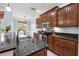 Modern kitchen featuring stainless steel appliances, granite countertops, and wood cabinetry at 7887 Limestone Ln # 12-102, Sarasota, FL 34233