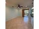 Living area with tile flooring, ceiling fan, and sliding glass doors leading to the outdoors at 7887 Limestone Ln # 12-102, Sarasota, FL 34233
