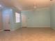 Spacious living room with tile flooring, a ceiling fan, and natural light from a window at 7887 Limestone Ln # 12-102, Sarasota, FL 34233