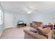 Cozy living room features neutral walls, tile flooring, and a ceiling fan for a bright, airy feel at 7887 Limestone Ln # 12-102, Sarasota, FL 34233
