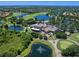 Gorgeous aerial view of golf course community, lakes, and clubhouse with ample parking at 7934 Royal Birkdale Cir, Lakewood Ranch, FL 34202