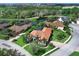 Aerial view of a luxury home showcasing lush landscaping and a serene lake backdrop at 7934 Royal Birkdale Cir, Lakewood Ranch, FL 34202