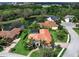 Beautiful home featuring well-manicured lawn and garden, mature palms and barrel tile roof in lakefront community at 7934 Royal Birkdale Cir, Lakewood Ranch, FL 34202