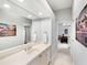 Bathroom vanity with double doors to toilet and bedroom with large mirror at 7934 Royal Birkdale Cir, Lakewood Ranch, FL 34202