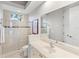 Bright bathroom featuring a glass shower, tile flooring, neutral walls, and a white vanity at 7934 Royal Birkdale Cir, Lakewood Ranch, FL 34202