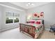 Comfortable bedroom features carpet, a traditional bed frame, and a window with a view at 7934 Royal Birkdale Cir, Lakewood Ranch, FL 34202