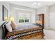 Comfortable bedroom features carpet, a traditional bed frame, a window with a view, and ceiling fan at 7934 Royal Birkdale Cir, Lakewood Ranch, FL 34202