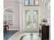 Spacious foyer featuring beautiful tile floor, designer double door and transom window at 7934 Royal Birkdale Cir, Lakewood Ranch, FL 34202