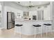 Modern kitchen featuring stainless steel appliances, a center island with breakfast bar, and white cabinetry at 7934 Royal Birkdale Cir, Lakewood Ranch, FL 34202