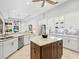 Open kitchen with a large island, breakfast bar, stainless steel appliances, and seamless transition to the dining area at 7934 Royal Birkdale Cir, Lakewood Ranch, FL 34202
