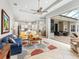 Spacious living room with a view of the kitchen, dining area, and an open patio at 7934 Royal Birkdale Cir, Lakewood Ranch, FL 34202