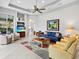 Comfortable living room with a stylish rug, ceiling fan, and a built-in display cabinet at 7934 Royal Birkdale Cir, Lakewood Ranch, FL 34202