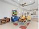 Spacious living room with a stylish rug, ceiling fan, and a view of the kitchen at 7934 Royal Birkdale Cir, Lakewood Ranch, FL 34202