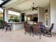 Outdoor dining area with a built-in grill and ample seating for entertaining guests at 7934 Royal Birkdale Cir, Lakewood Ranch, FL 34202
