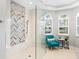 Beautiful shower features a glass enclosure, modern fixtures, and a chevron tile accent wall at 7934 Royal Birkdale Cir, Lakewood Ranch, FL 34202