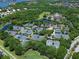 Aerial view of multiple tennis courts nestled amongst trees, providing a recreational amenity for residents at 7934 Royal Birkdale Cir, Lakewood Ranch, FL 34202