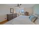 Spacious main bedroom with a ceiling fan, neutral tones, dressers, and a water view through a window at 814 Bayport Way, Longboat Key, FL 34228