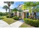 Townhome exterior with lush tropical landscaping and a well-maintained sidewalk at 8926 Manor Loop # 206, Lakewood Ranch, FL 34202