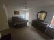 Main bedroom featuring neutral walls, ceiling fan, and updated furniture with a large window at 9112 Bell Rock Pl, Land O Lakes, FL 34638