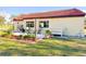 Enjoy outdoor dining on the backyard patio with manicured flowerbeds at 916 W Faith Cir, Bradenton, FL 34212