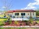 Inviting backyard patio, perfect for relaxing and grilling, with colorful flowerbeds at 916 W Faith Cir, Bradenton, FL 34212