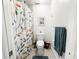Bright and airy bathroom with a colorful shower curtain, tile floors, and modern fixtures at 916 W Faith Cir, Bradenton, FL 34212