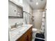 Well lit bathroom with a granite-look vanity and tiled shower at 916 W Faith Cir, Bradenton, FL 34212