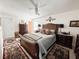 This bedroom features light hardwood floors, a ceiling fan, and tasteful decorations at 916 W Faith Cir, Bradenton, FL 34212