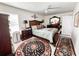 This bedroom features light hardwood floors, a ceiling fan, and tasteful decorations at 916 W Faith Cir, Bradenton, FL 34212