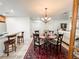 Dining area featuring modern lighting, seating for four and seamless flow to kitchen at 916 W Faith Cir, Bradenton, FL 34212