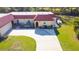 Aerial view of the home showcasing the inviting front entrance, lush landscaping, and circular driveway at 916 W Faith Cir, Bradenton, FL 34212