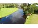Scenic waterfront view with lush greenery, boats, and glimpses of nearby buildings at 916 W Faith Cir, Bradenton, FL 34212
