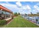 Backyard showing the canal, boat dock, boat lift, and patio with furniture at 9527 Azure Cv, Bradenton, FL 34210
