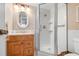 Bright bathroom featuring a glass-enclosed shower, wood vanity, and neutral decor at 9527 Azure Cv, Bradenton, FL 34210
