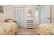 Bedroom featuring two beds, closet, and light wood-look flooring at 9527 Azure Cv, Bradenton, FL 34210
