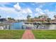 View of boat on lift and canal with waterfront properties at 9527 Azure Cv, Bradenton, FL 34210