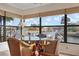 Dining area with scenic water view and modern glass-top table, perfect for casual meals and entertaining at 9527 Azure Cv, Bradenton, FL 34210