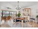 Elegant dining area with hardwood floors, a charming hutch, and natural light, perfect for Gathering gatherings at 9527 Azure Cv, Bradenton, FL 34210