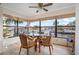 Waterfront dining area with floor-to-ceiling windows offering stunning views of the waterway at 9527 Azure Cv, Bradenton, FL 34210