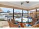 Dining area with scenic water view and modern glass-top table, perfect for casual meals and entertaining at 9527 Azure Cv, Bradenton, FL 34210