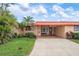 Inviting single-story home featuring lush landscaping, a covered entryway, and a spacious driveway at 9527 Azure Cv, Bradenton, FL 34210