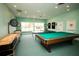 Bright game room featuring a pool table, shuffleboard, ping pong, and dart board for recreation and entertainment at 9527 Azure Cv, Bradenton, FL 34210