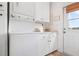 Laundry room featuring stackable washer and dryer and plenty of white cabinet space at 9527 Azure Cv, Bradenton, FL 34210