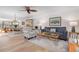 Bright and airy living space with hardwood floors, comfortable seating, and an adjacent dining area at 9527 Azure Cv, Bradenton, FL 34210
